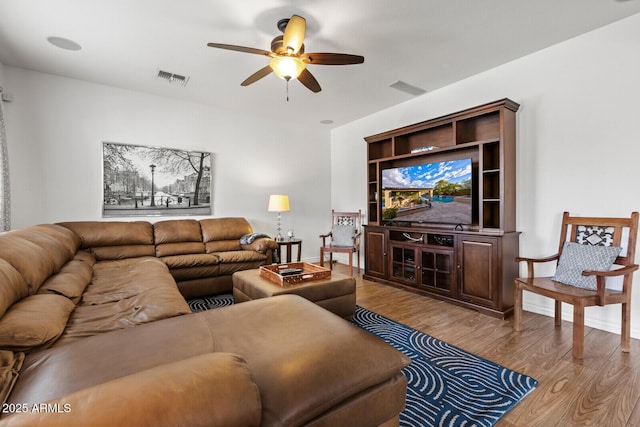 living room featuring ceiling fan and light hardwood / wood-style flooring