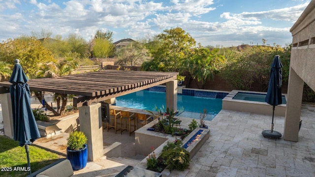 view of pool with an in ground hot tub, a pergola, exterior bar, and a patio