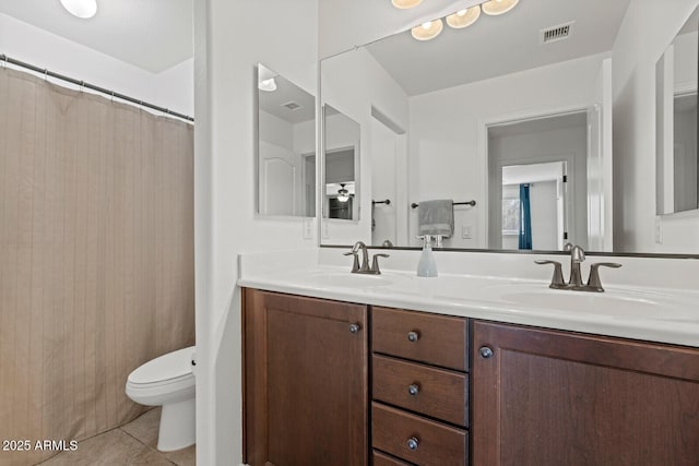 bathroom with toilet, vanity, tile patterned floors, and a shower with shower curtain