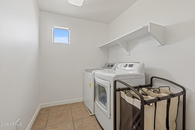 laundry room featuring light tile patterned floors and washer and dryer