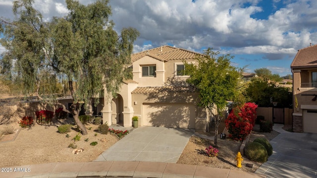 mediterranean / spanish-style house with a garage