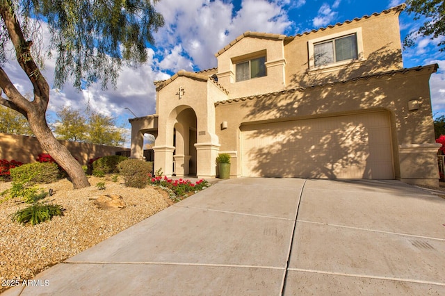 mediterranean / spanish home featuring a garage