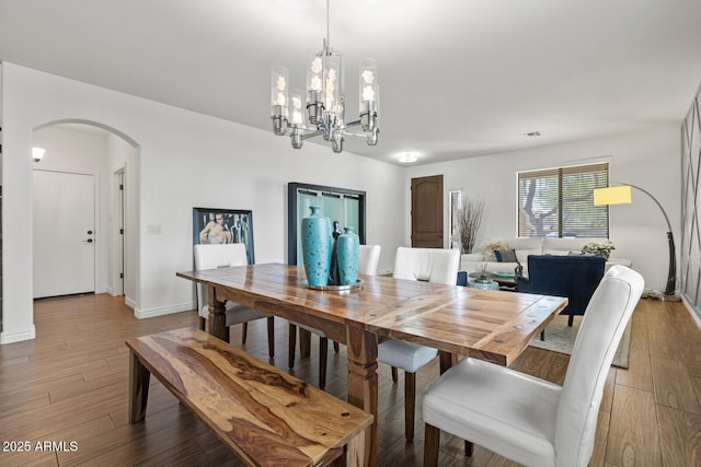 dining area with a chandelier and hardwood / wood-style floors