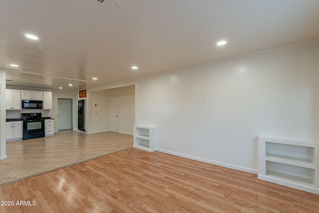 unfurnished living room with baseboards, ornamental molding, light wood-type flooring, and recessed lighting