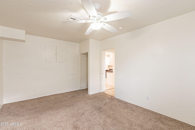 spare room featuring light carpet, ceiling fan, and visible vents