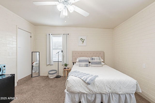 bedroom featuring ceiling fan and brick wall