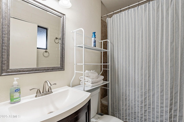 bathroom featuring toilet, vanity, and a shower with shower curtain