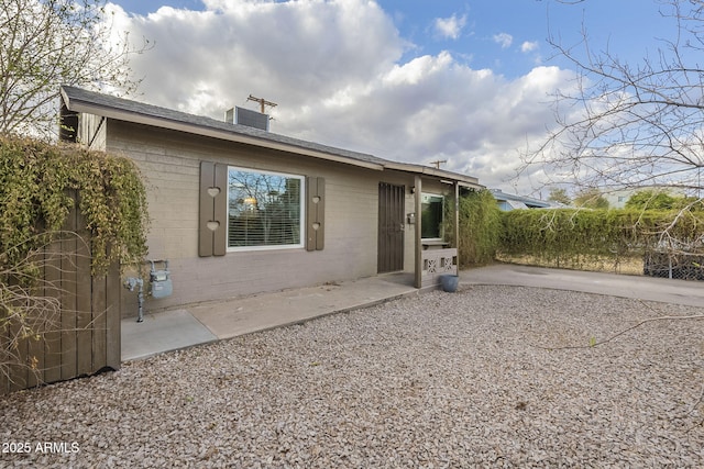 rear view of property featuring a patio, a chimney, and central air condition unit