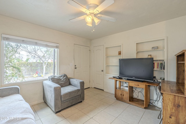 living area featuring light tile patterned floors, ceiling fan, and built in features