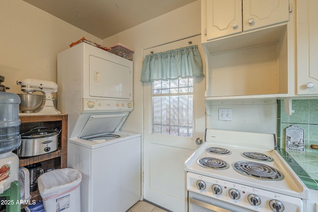 laundry room featuring stacked washer and clothes dryer, light tile patterned floors, and laundry area