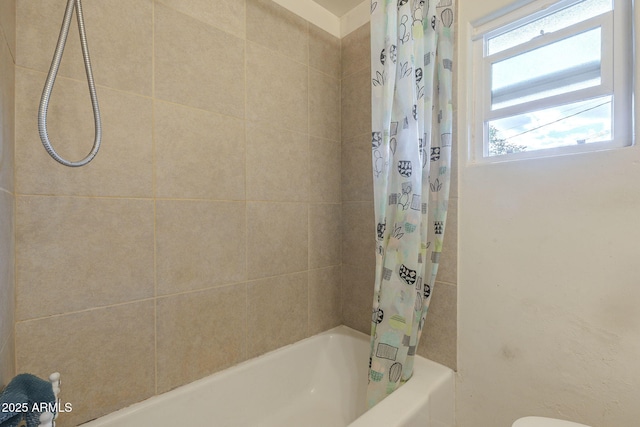 bathroom with shower / bath combo with shower curtain