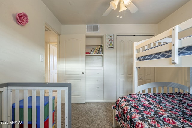 carpeted bedroom with a ceiling fan and visible vents