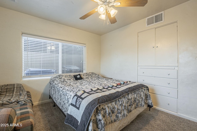 bedroom featuring carpet floors, multiple windows, visible vents, and baseboards