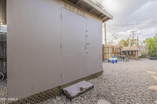 view of shed featuring fence