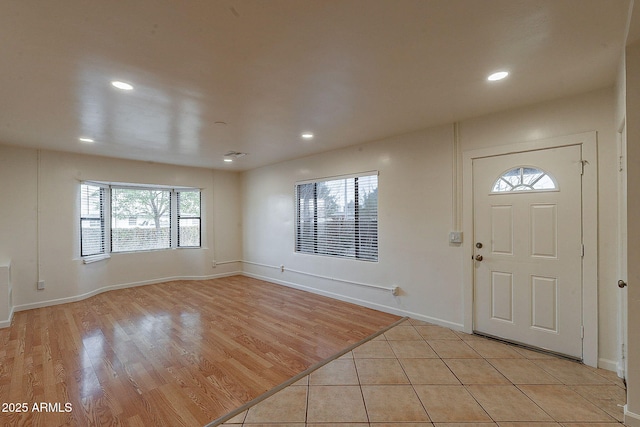 foyer featuring baseboards, recessed lighting, and light wood-style floors