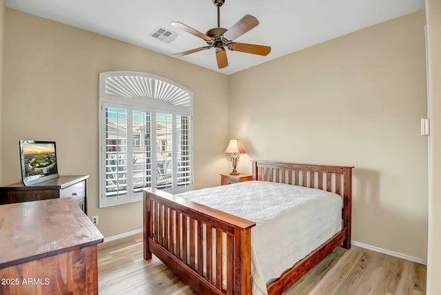 bedroom with baseboards, visible vents, ceiling fan, and light wood finished floors