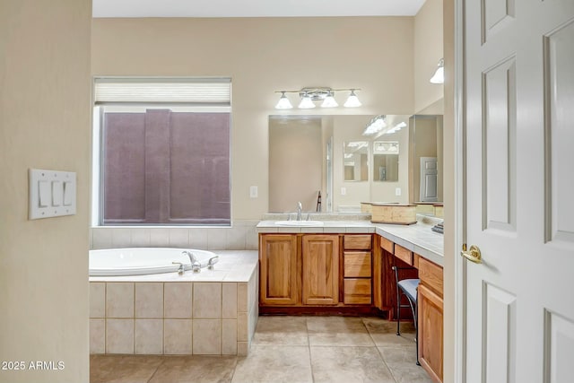 full bathroom with tile patterned flooring, a garden tub, and vanity