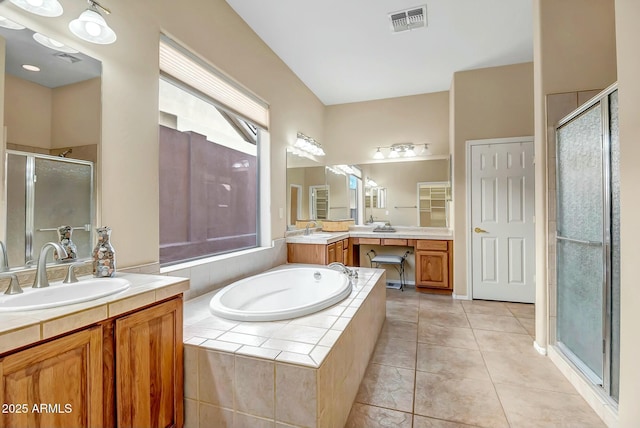 bathroom with a stall shower, visible vents, a sink, tile patterned flooring, and a bath
