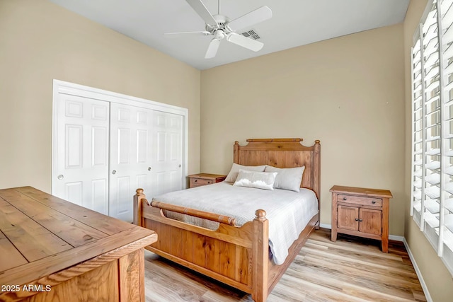 bedroom featuring light wood-style flooring, visible vents, baseboards, and a closet