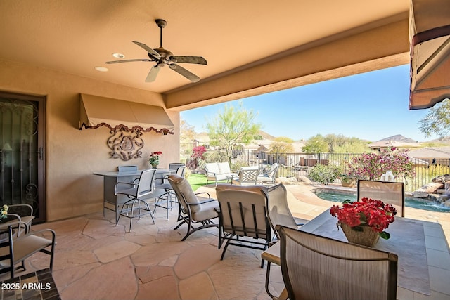 view of patio featuring a fenced backyard, a fenced in pool, a ceiling fan, and outdoor dining space