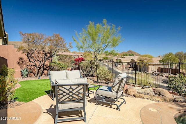 view of patio / terrace with a mountain view, a fenced backyard, and an outdoor living space
