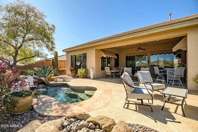 view of swimming pool with ceiling fan, a patio area, fence, and a fenced in pool