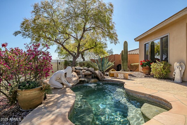 view of pool with a fenced backyard