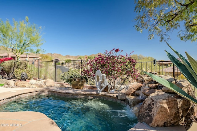 view of pool featuring a mountain view, fence, and a fenced in pool