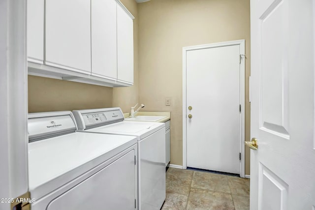 laundry room with cabinet space, a sink, baseboards, and separate washer and dryer