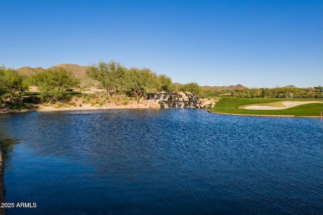 property view of water featuring view of golf course and a mountain view