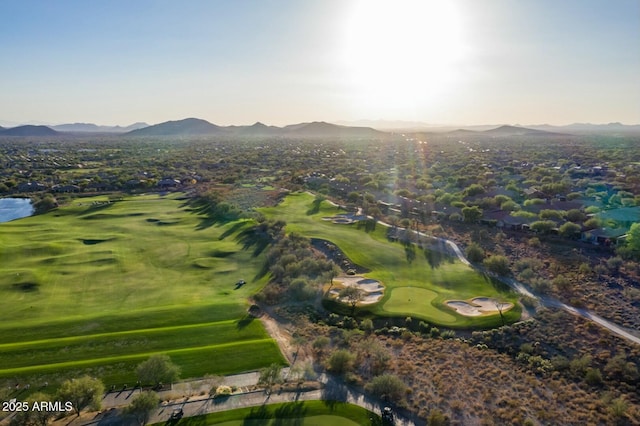 drone / aerial view featuring view of golf course and a mountain view