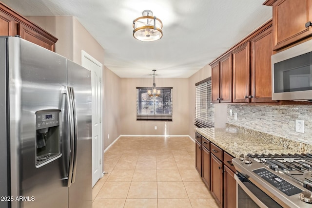 kitchen featuring light tile patterned floors, stainless steel appliances, backsplash, light stone countertops, and an inviting chandelier