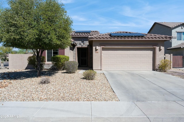 view of front of home with an attached garage, driveway, a tiled roof, and stucco siding