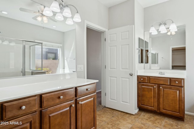 bathroom featuring a ceiling fan, a stall shower, and vanity