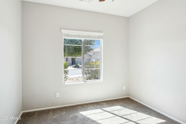 unfurnished room with carpet floors, ceiling fan, visible vents, and baseboards