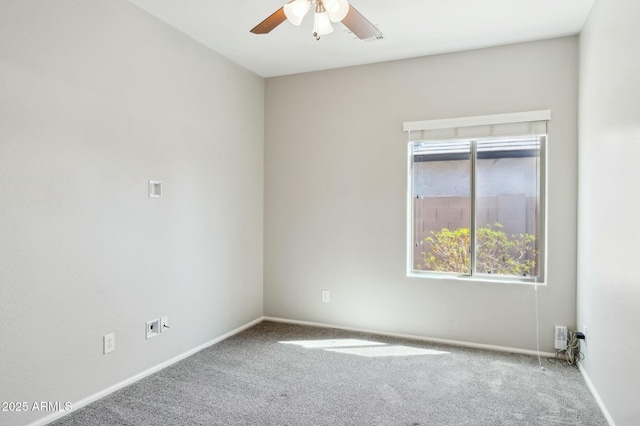 empty room with carpet flooring, ceiling fan, and baseboards