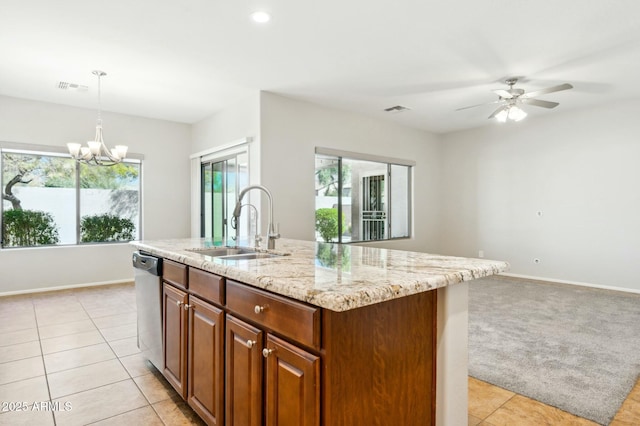 kitchen with visible vents, a sink, stainless steel dishwasher, and light stone countertops