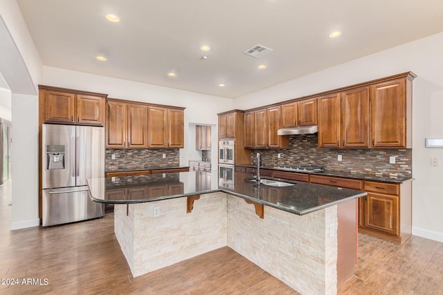5713 W Rowel Rd, Phoenix, AZ 85083 - kitchen with a spacious island, appliances with stainless steel finishes, a kitchen bar, and sink