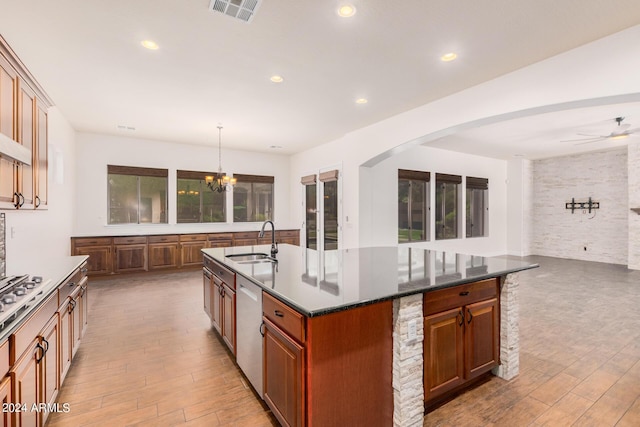 5713 W Rowel Rd, Phoenix, AZ 85083 - kitchen featuring sink, hanging light fixtures, a kitchen island with sink, stainless steel appliances, and light hardwood / wood-style flooring