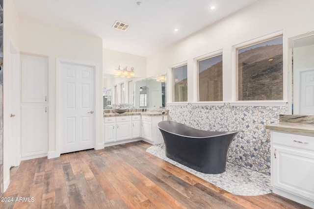 5713 W Rowel Rd, Phoenix, AZ 85083 - bathroom featuring hardwood / wood-style flooring, vanity, and a bath