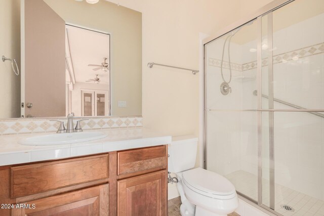 5713 W Rowel Rd, Phoenix, AZ 85083 - bathroom featuring tasteful backsplash, vanity, an enclosed shower, and toilet