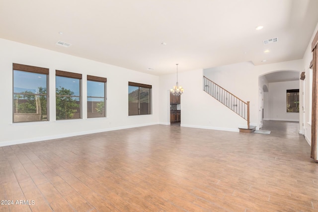 5713 W Rowel Rd, Phoenix, AZ 85083 - unfurnished living room featuring hardwood / wood-style floors and a chandelier
