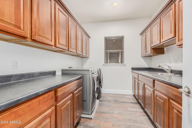 5713 W Rowel Rd, Phoenix, AZ 85083 - washroom featuring cabinets, sink, washing machine and clothes dryer, and light wood-type flooring