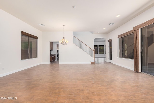 5713 W Rowel Rd, Phoenix, AZ 85083 - unfurnished living room with hardwood / wood-style flooring and a chandelier