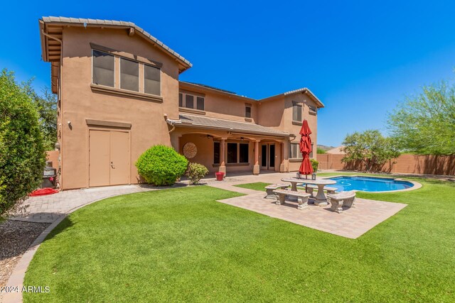 5713 W Rowel Rd, Phoenix, AZ 85083 - rear view of house featuring a fenced in pool, a patio, ceiling fan, and a lawn