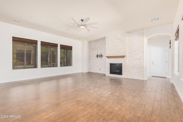 5713 W Rowel Rd, Phoenix, AZ 85083 - unfurnished living room with hardwood / wood-style flooring, ceiling fan, and a fireplace