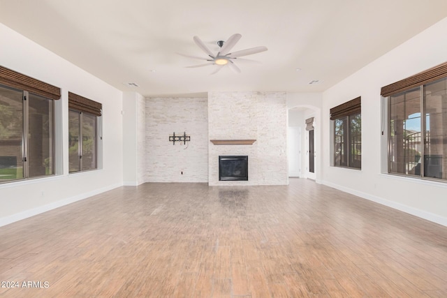 5713 W Rowel Rd, Phoenix, AZ 85083 - unfurnished living room featuring wood-type flooring, ceiling fan, and a fireplace