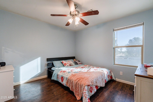 bedroom with ceiling fan and dark hardwood / wood-style floors