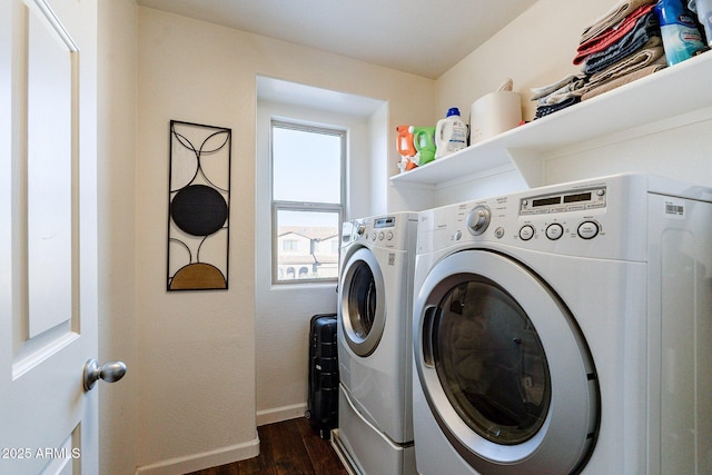 washroom with dark hardwood / wood-style flooring and washing machine and clothes dryer