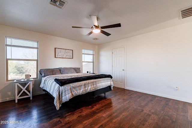 bedroom with ceiling fan, dark hardwood / wood-style floors, and multiple windows